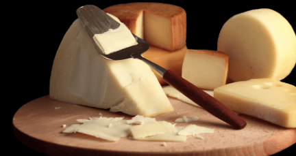 Slices of cheese on a cheese board Slices of cheese on a cheese board